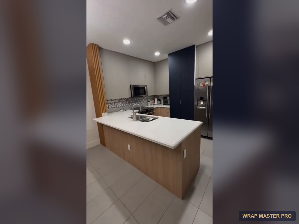 Navy acrylic pantry wall framed by light gray and woodgrain cabinets, South Florida