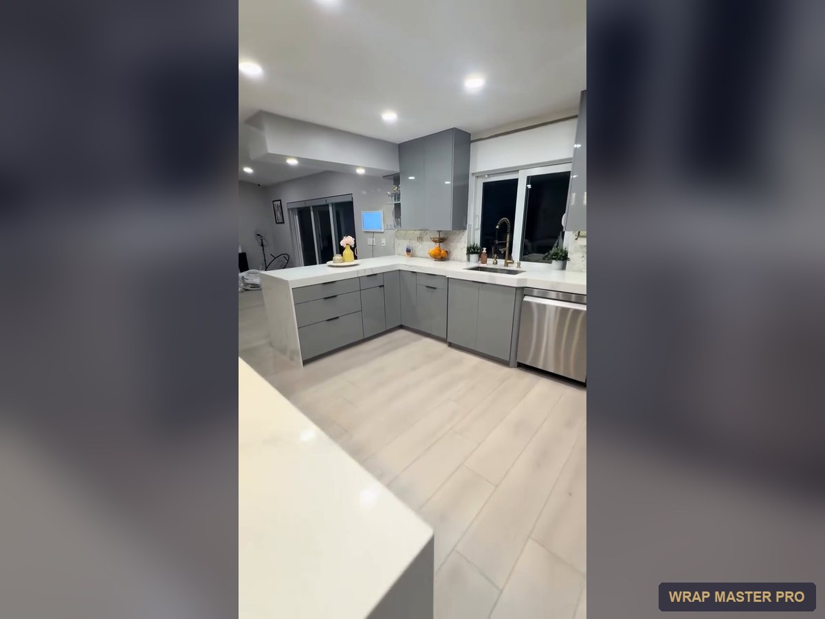 Gray high-gloss acrylic kitchen with a waterfall peninsula, South Florida