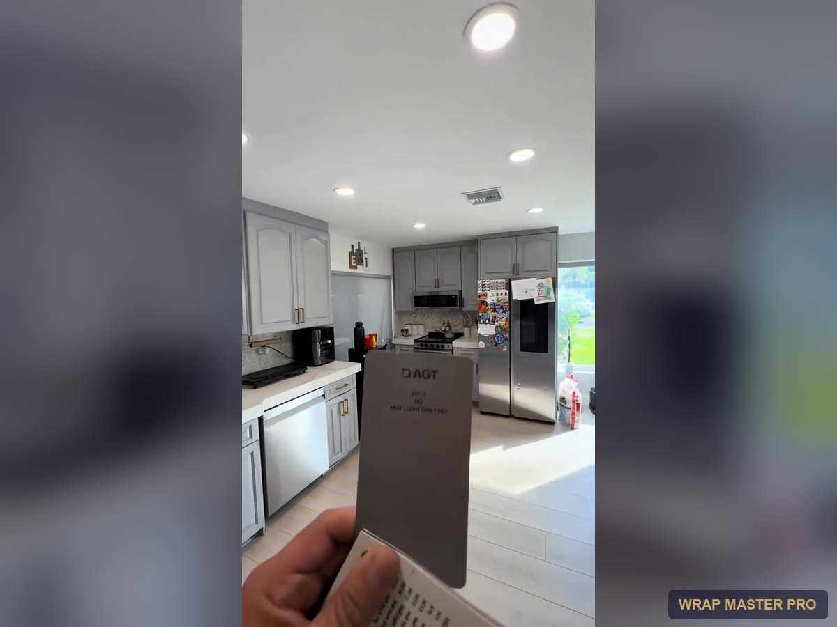 Gray high-gloss acrylic kitchen with a waterfall peninsula, South Florida