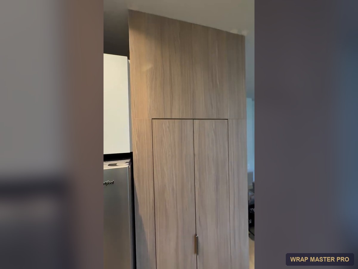Full-height natural oak-look pantry wall with flush doors, South Florida