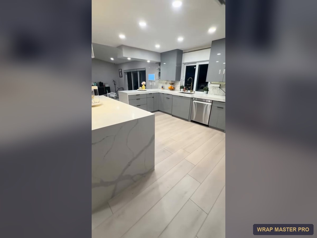 Gray high-gloss acrylic kitchen with a waterfall peninsula, South Florida