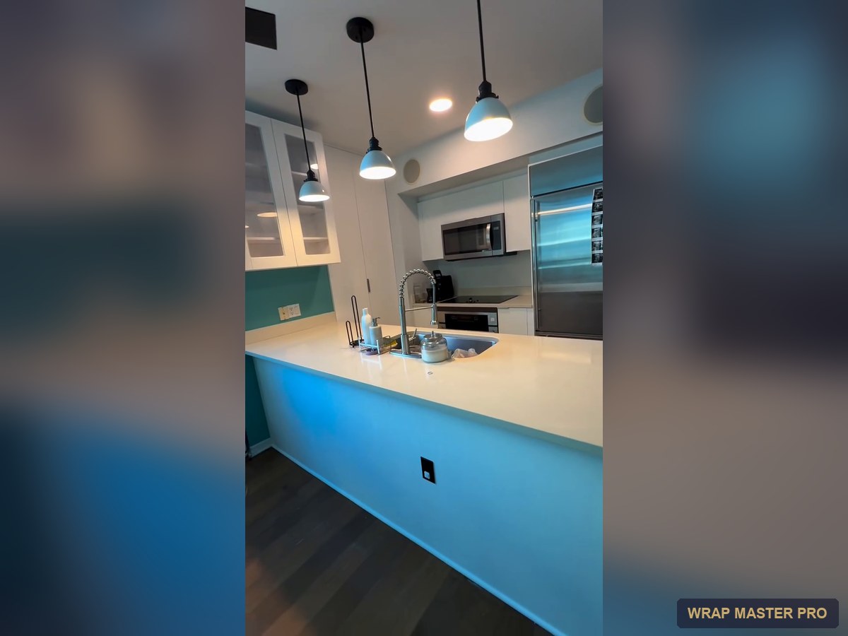 Bright white condo kitchen with an enclosed floor-to-ceiling pantry, South Florida