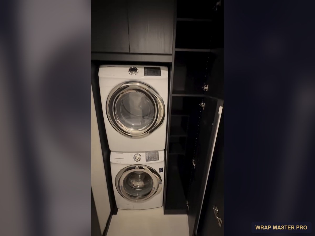 Built-in laundry closet with dark woodgrain cabinets, South Florida